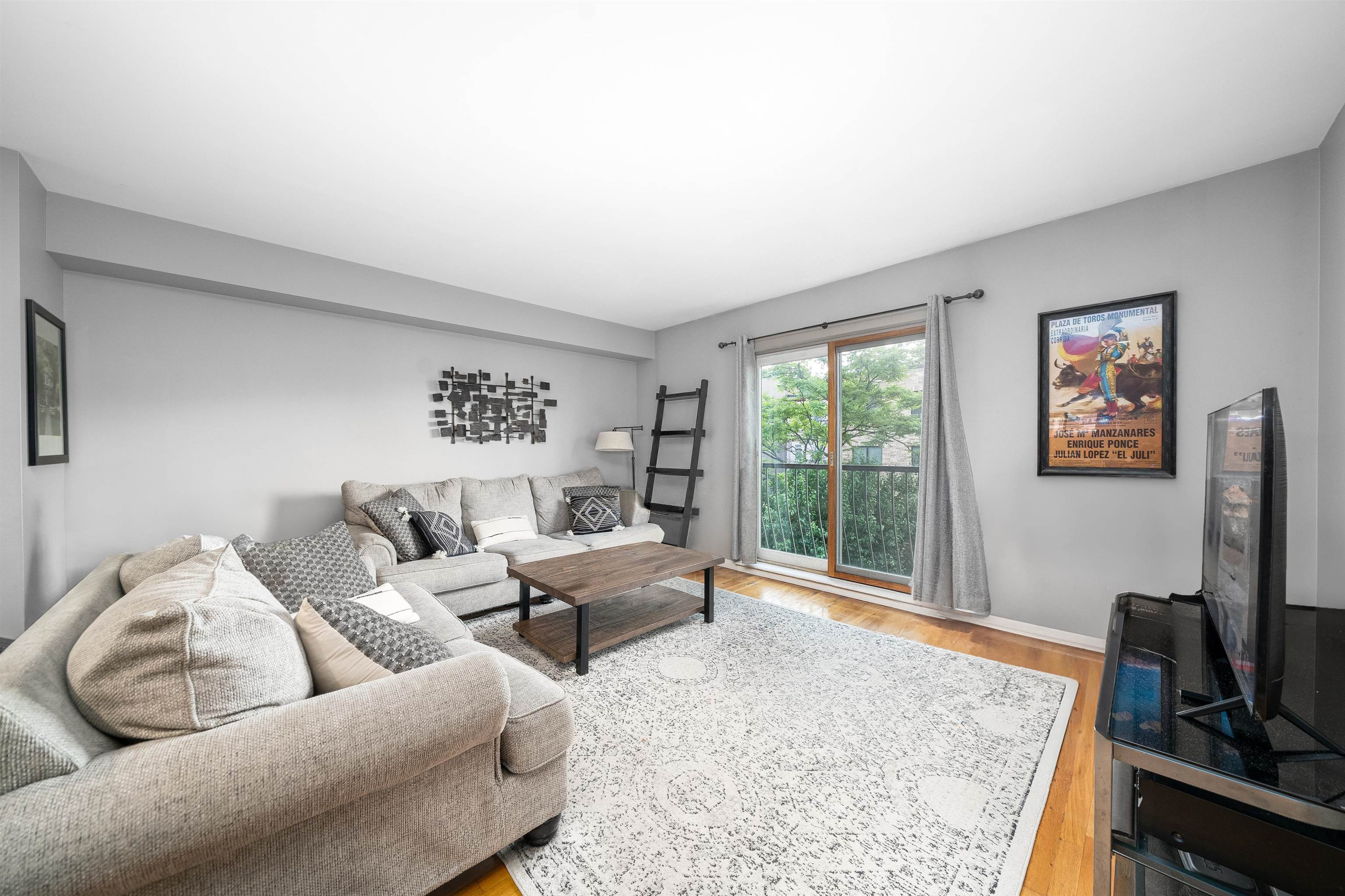 536 Grand Street, Unit 403 Hoboken, NJ 07030 - Photo 2 of 15 a living room with furniture a flat screen tv and a window