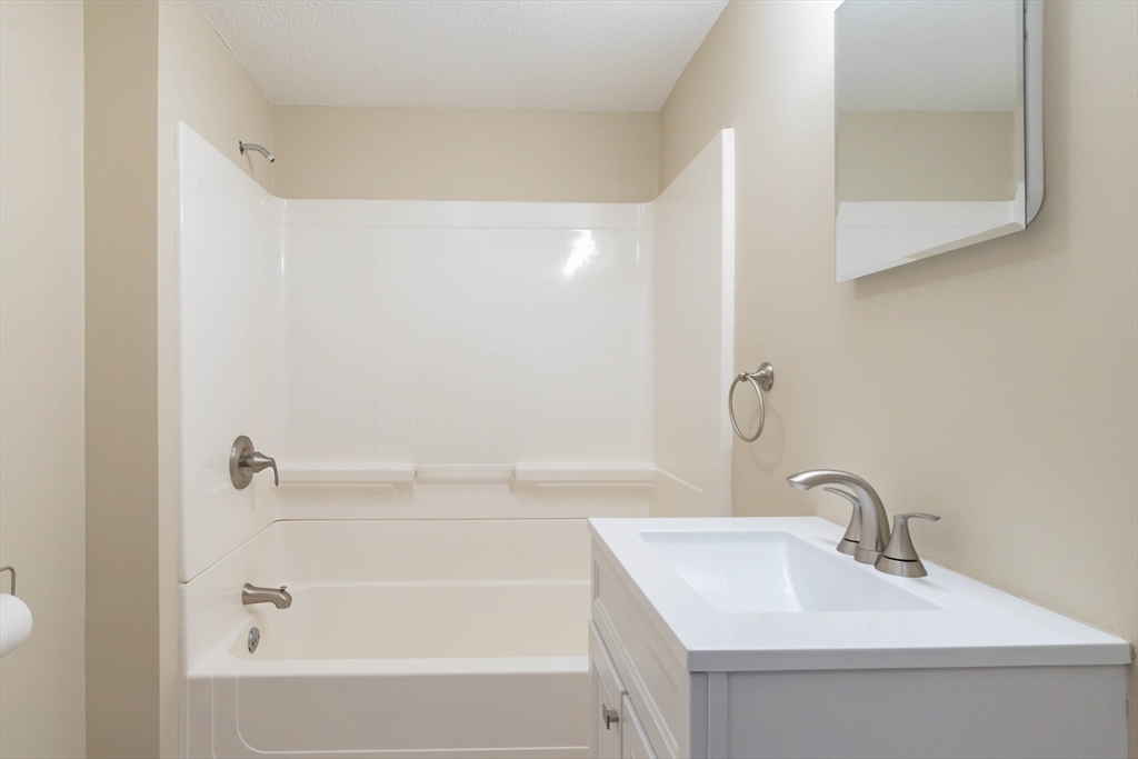 137 Lowell Road Pepperell, MA 01463 - Photo 18 of 40 a bathroom with a sink and a bathtub