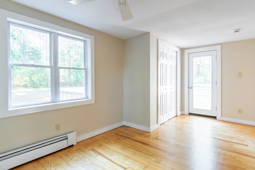 137 Lowell Road Pepperell, MA 01463 - Photo 20 of 40 a view of an empty room with wooden floor and a window