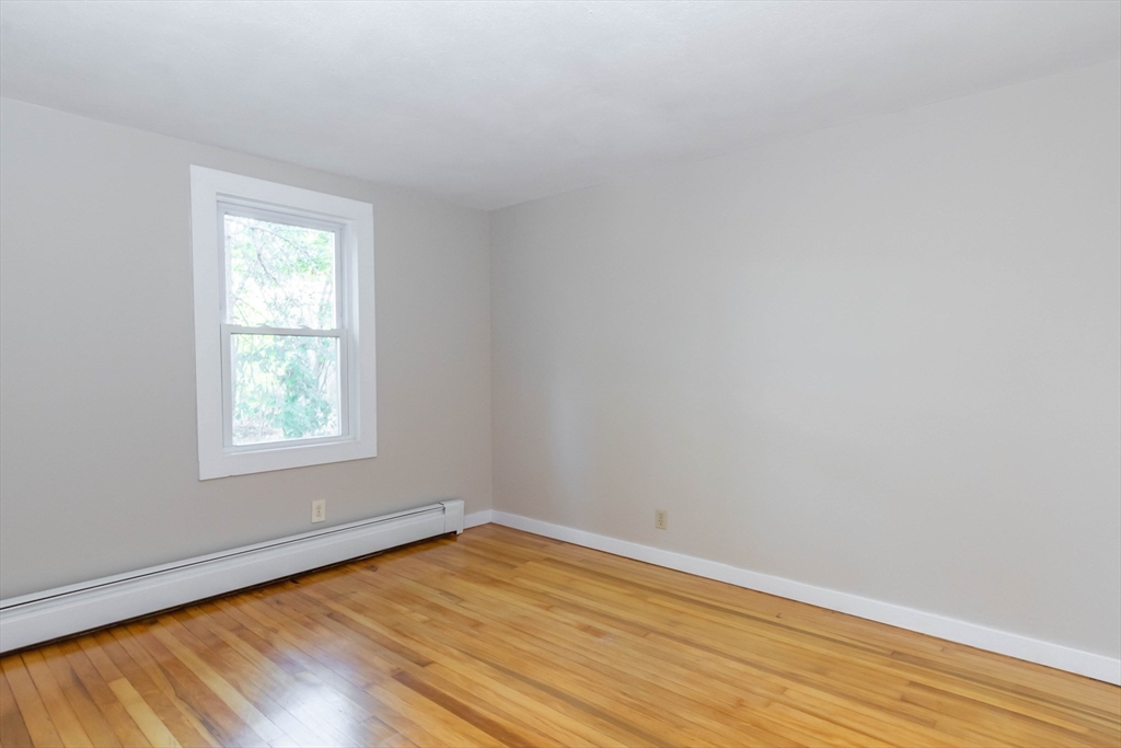 137 Lowell Road Pepperell, MA 01463 - Photo 21 of 40 an empty room with wooden floor and windows