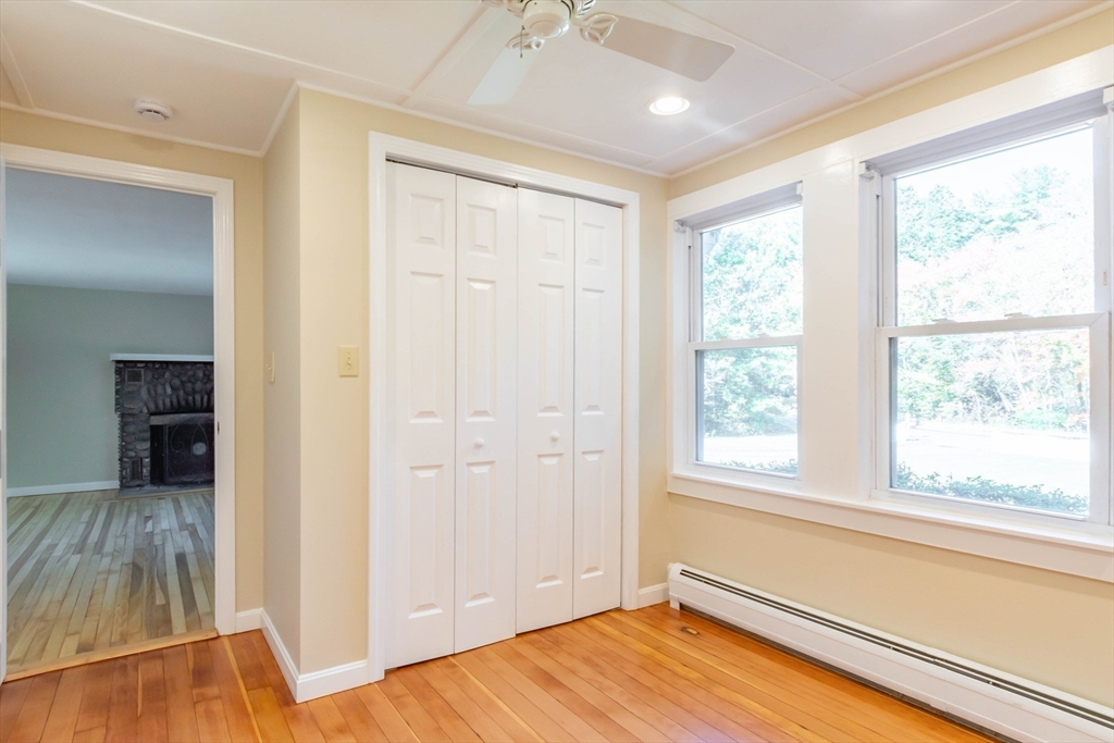 137 Lowell Road Pepperell, MA 01463 - Photo 23 of 40 a view of empty room with wooden floor and fan