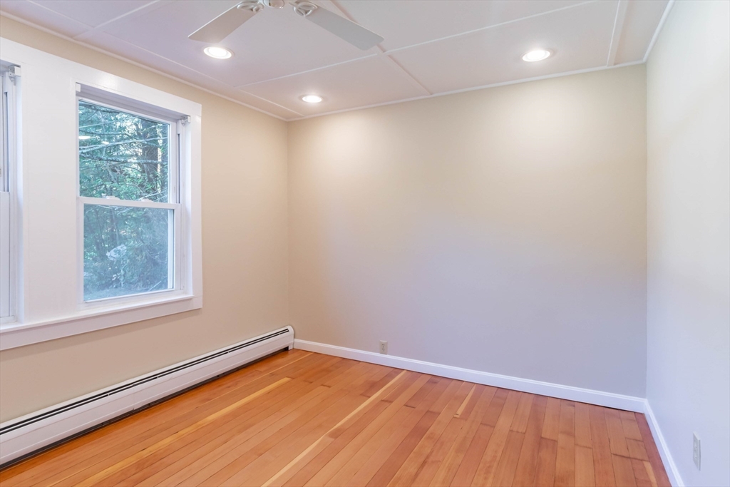 137 Lowell Road Pepperell, MA 01463 - Photo 24 of 40 an empty room with wooden floor and windows