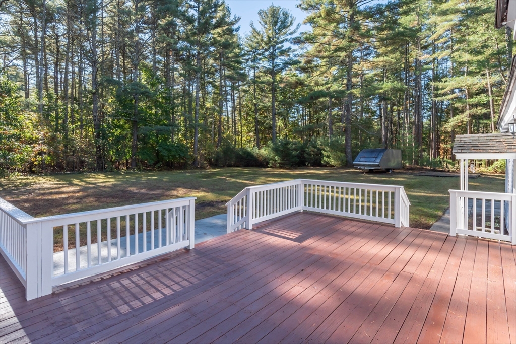 137 Lowell Road Pepperell, MA 01463 - Photo 25 of 40 a view of a deck with wooden floor and fence