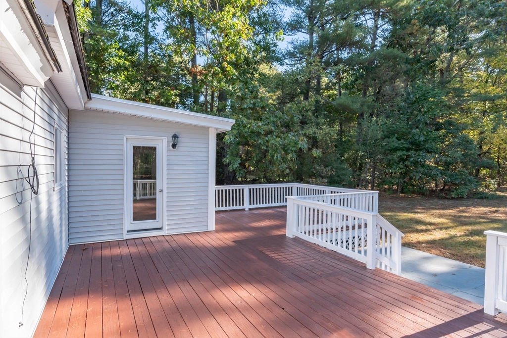 137 Lowell Road Pepperell, MA 01463 - Photo 40 of 40 a view of a wooden deck and a yard with wooden fence