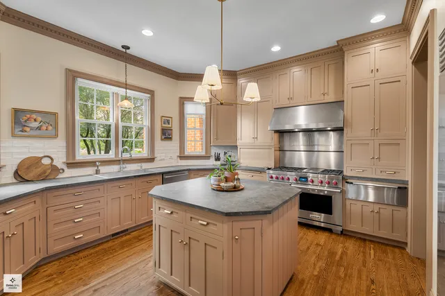 a kitchen with a sink stove and wooden cabinets