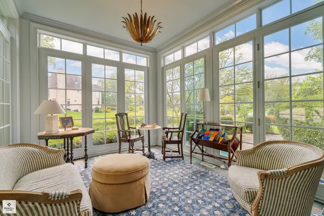 a living room with furniture and a floor to ceiling windows