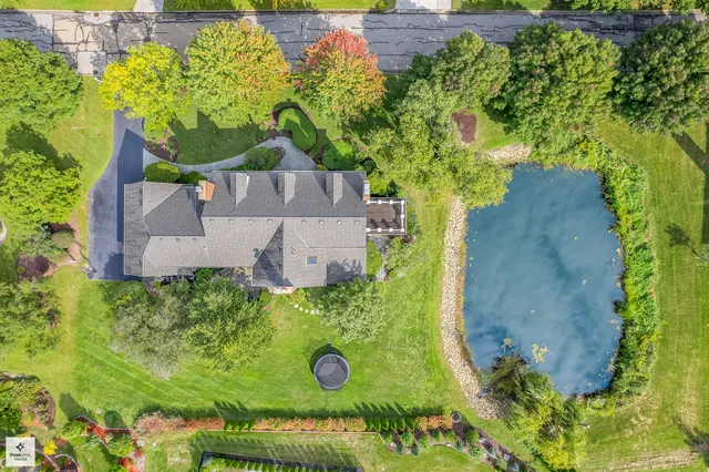 an aerial view of a house with a yard basket ball court and outdoor seating