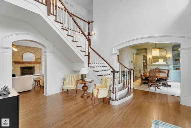 a living room with furniture a chandelier and a large window