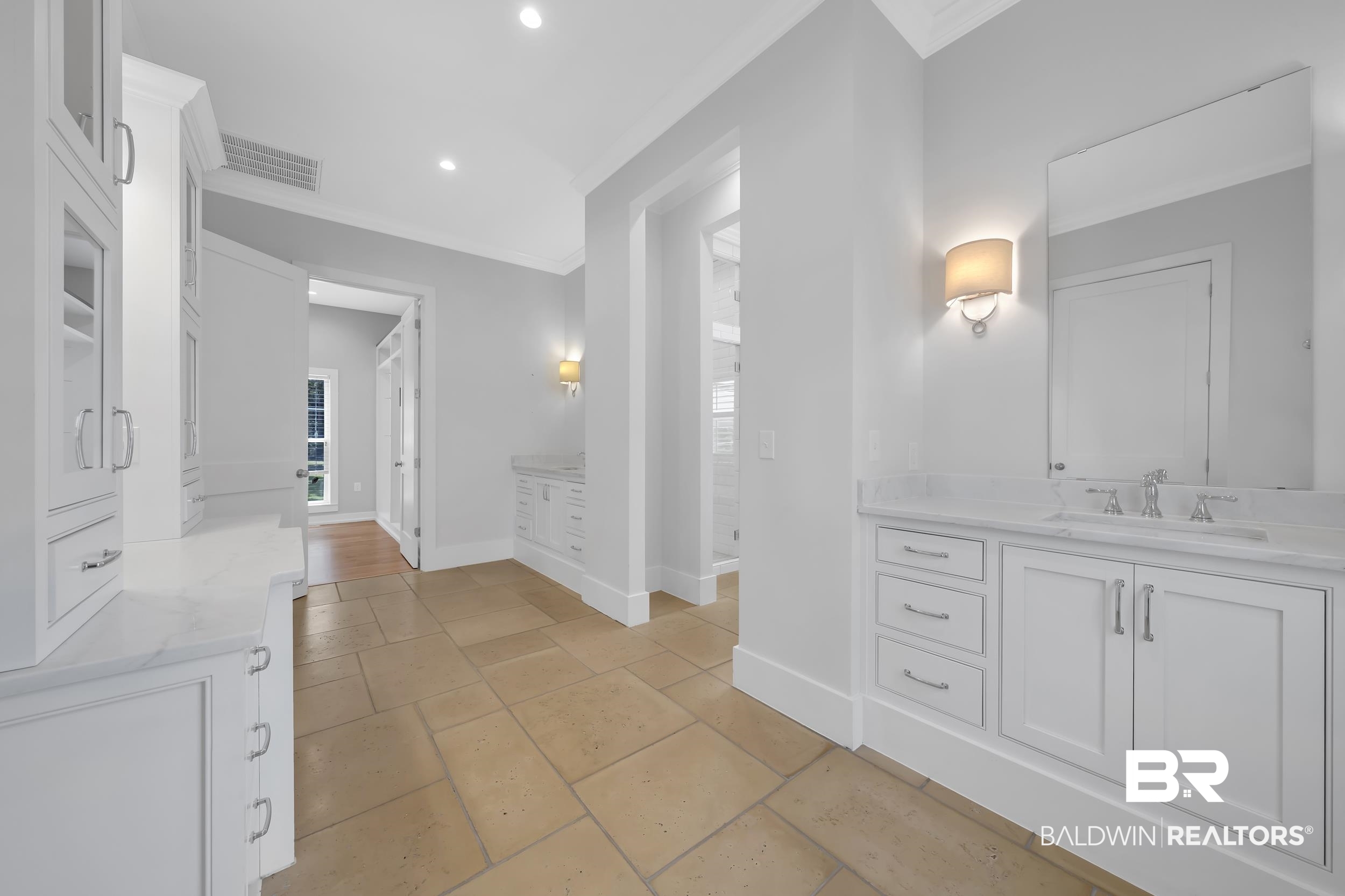 43199 Pine Grove Road Bay Minette, AL 36507 - Photo 46 of 71 Spacious bathroom area featuring a dual vanity, extensive white cabinetry with varied storage options, and stone tile flooring