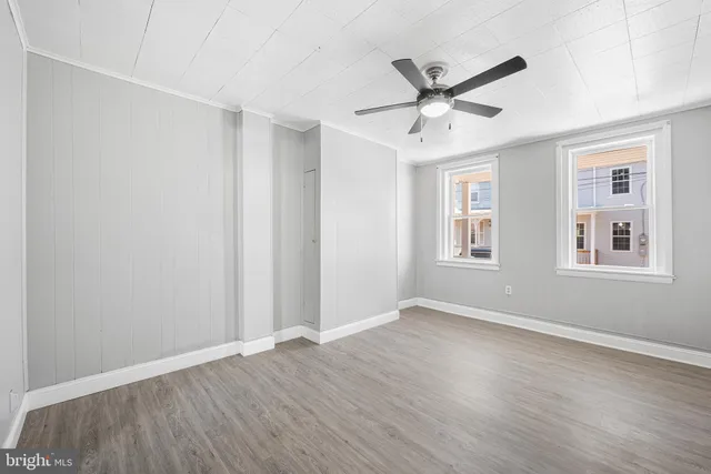 a view of an empty room with wooden floor