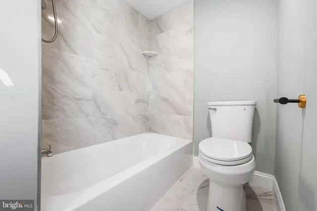 a view of a room with wooden floor and a ceiling fan