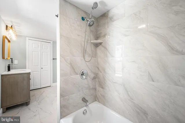 a bathroom with a bathtub and a shower
