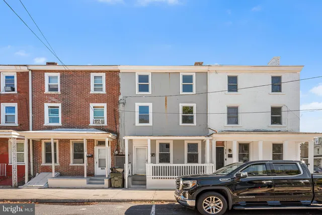 a front view of a building with parking space