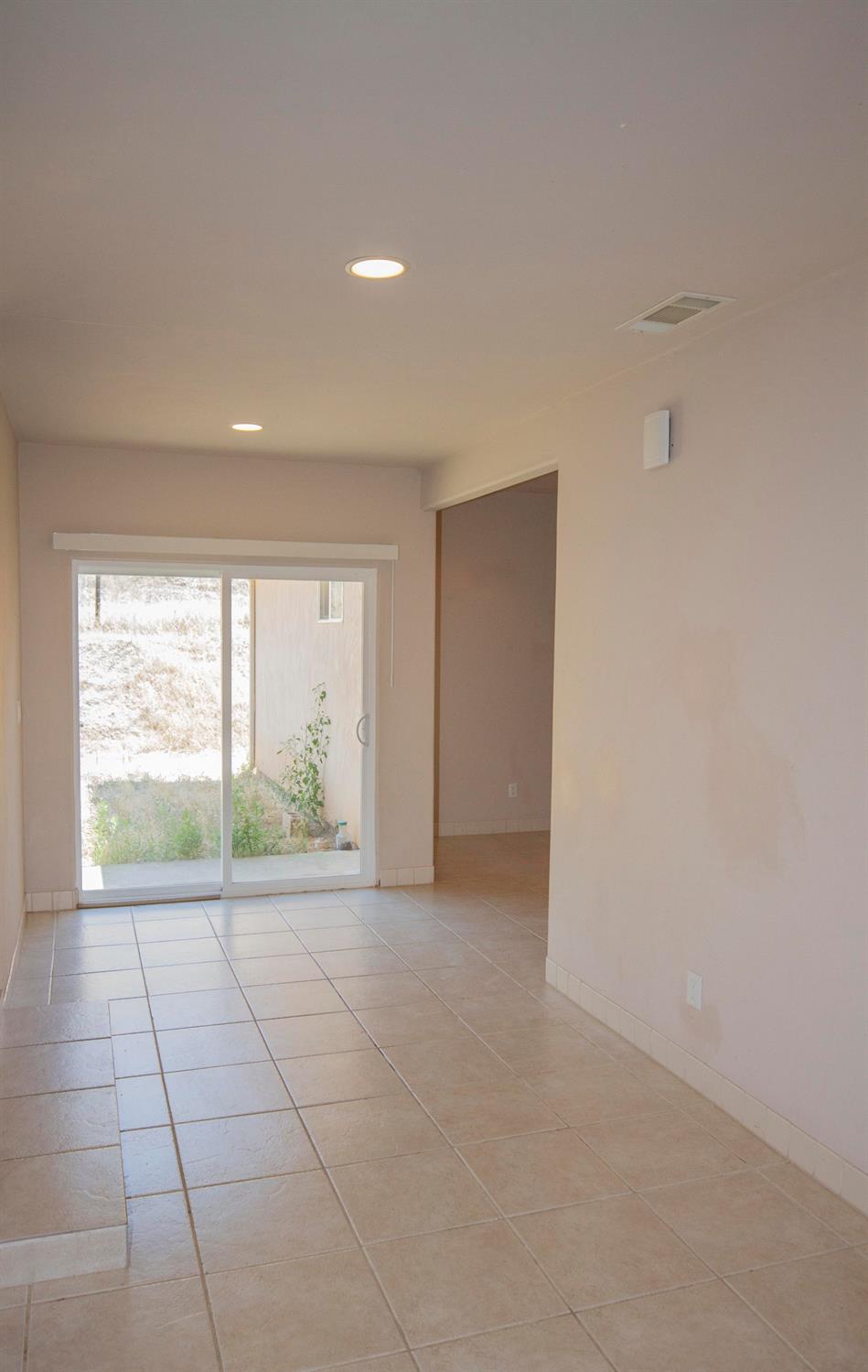 Entry way from front door. Hallway to the right goes to added bedrooms, bathroom and laundry. Left goes to kitchen, dining area, living room, bedroom and bathroom, and master suite.