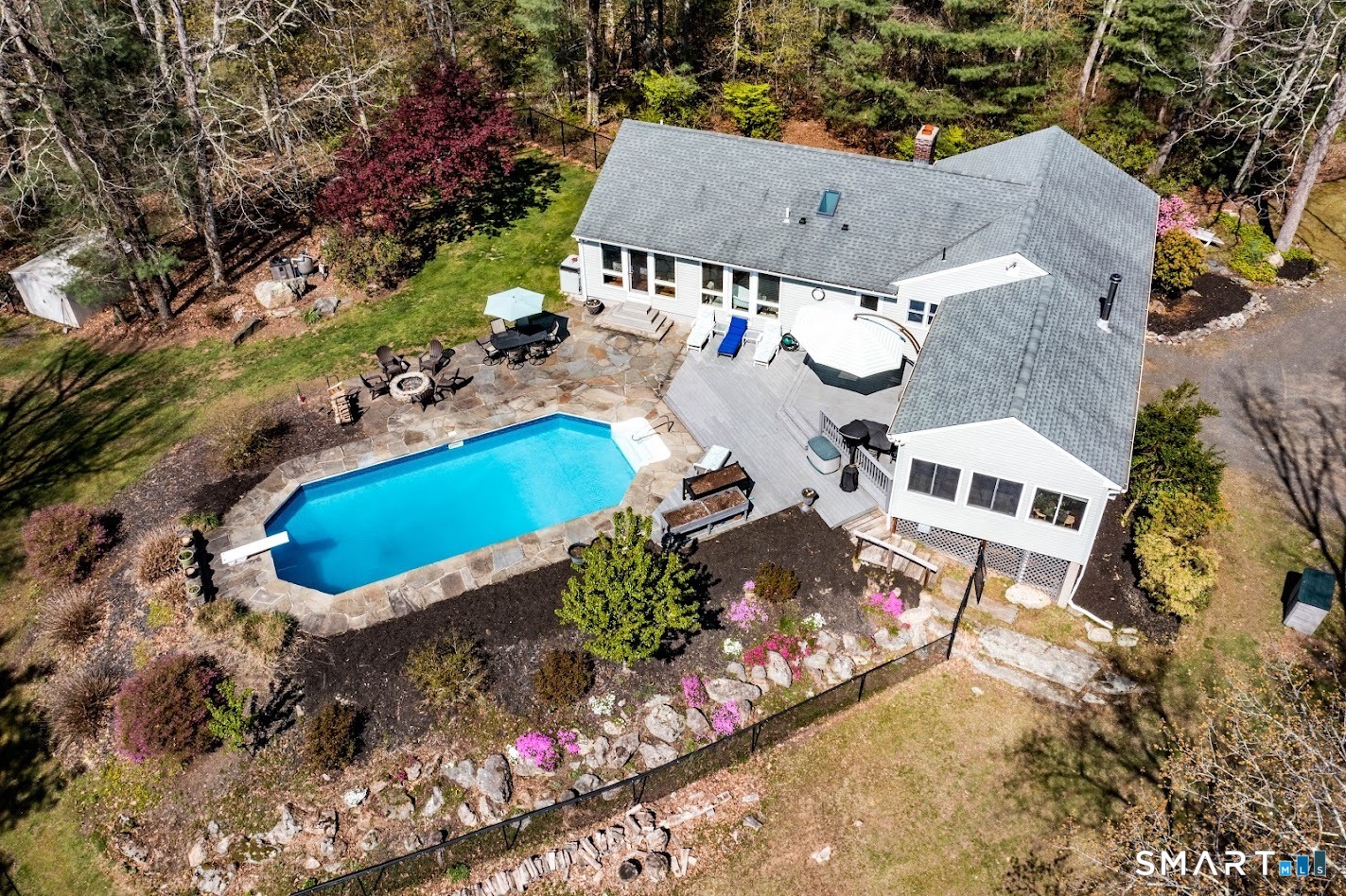 an aerial view of a house with a yard and lake view