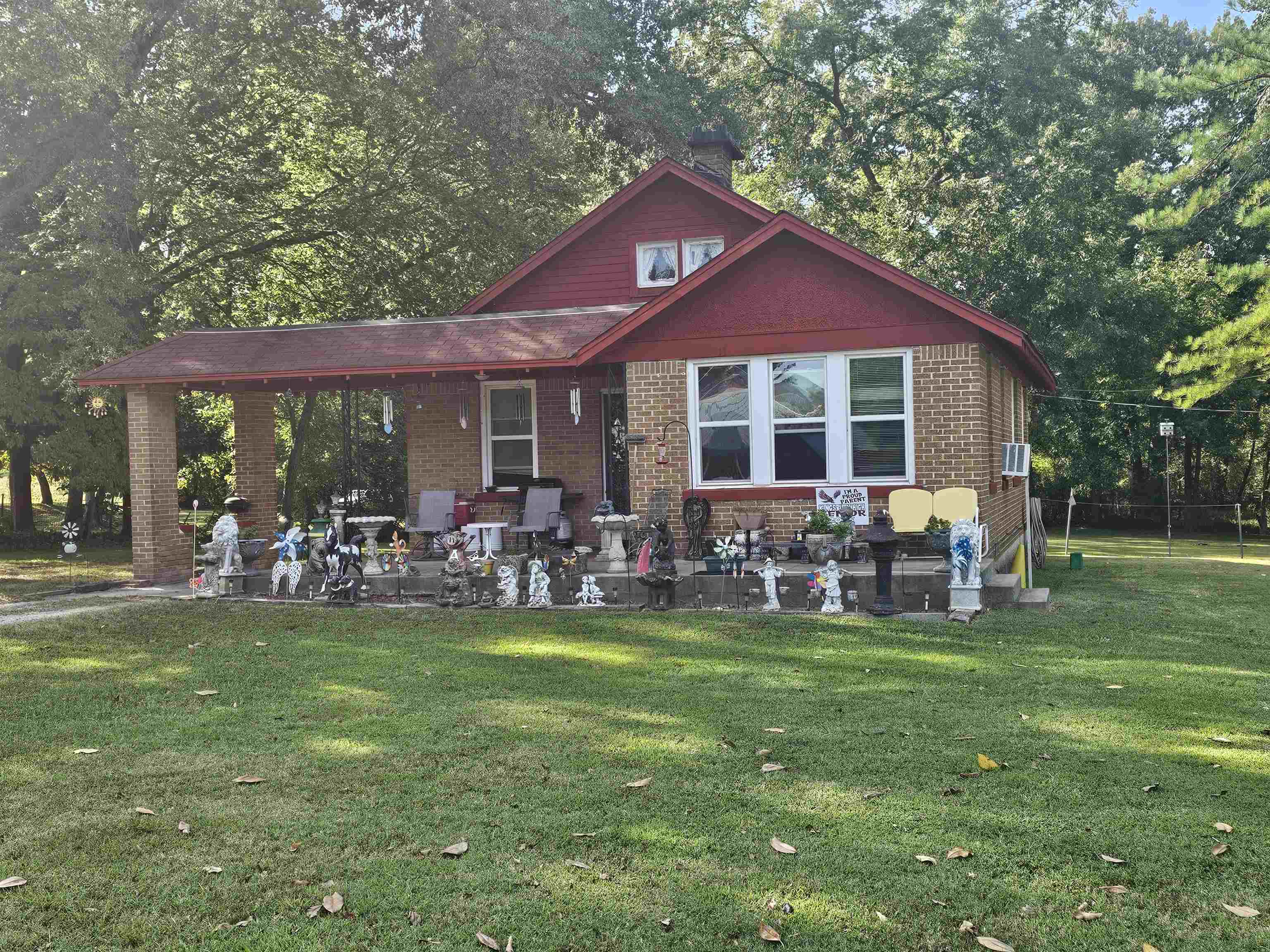 a view of a house with a yard and sitting area