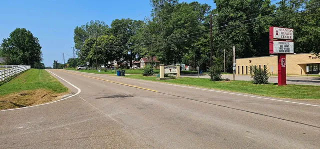 a sign board with a play ground in front of it