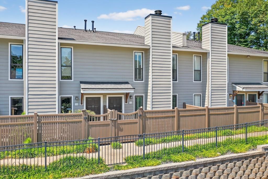 a view of a house with a backyard and a porch