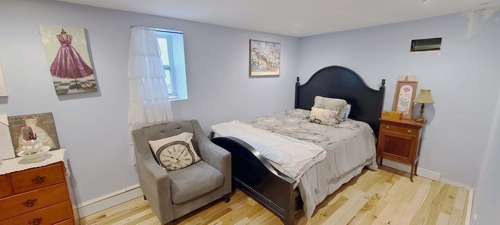 6 Sylvan Road Holbrook, MA 02343 - Photo 16 of 24 a bedroom with a bed and wooden floor