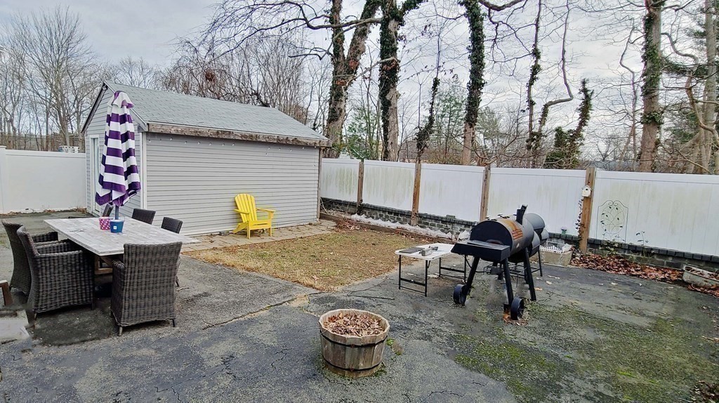 6 Sylvan Road Holbrook, MA 02343 - Photo 20 of 24 a backyard of a house with barbeque oven table and chairs