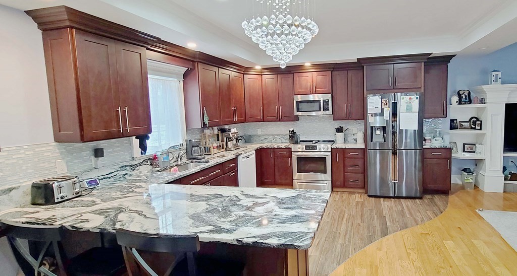 6 Sylvan Road Holbrook, MA 02343 - Photo 2 of 24 a kitchen with stainless steel appliances granite countertop a sink counter space and cabinets