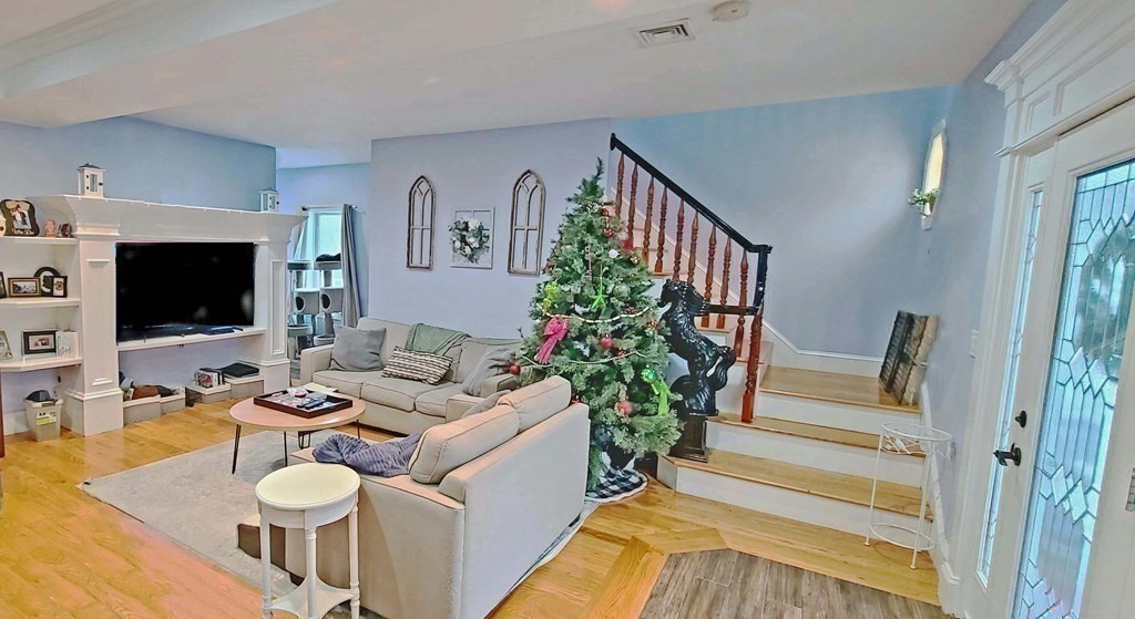 6 Sylvan Road Holbrook, MA 02343 - Photo 6 of 24 a living room with furniture potted plant and a flat screen tv