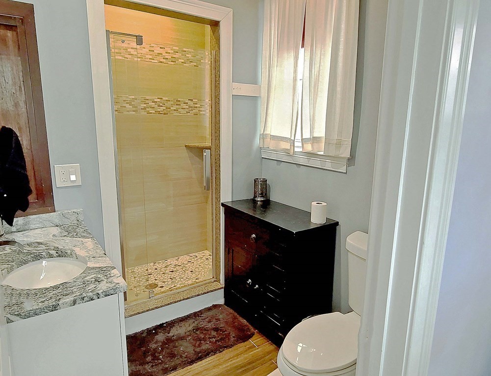 6 Sylvan Road Holbrook, MA 02343 - Photo 10 of 24 a bathroom with a granite countertop toilet sink and mirror