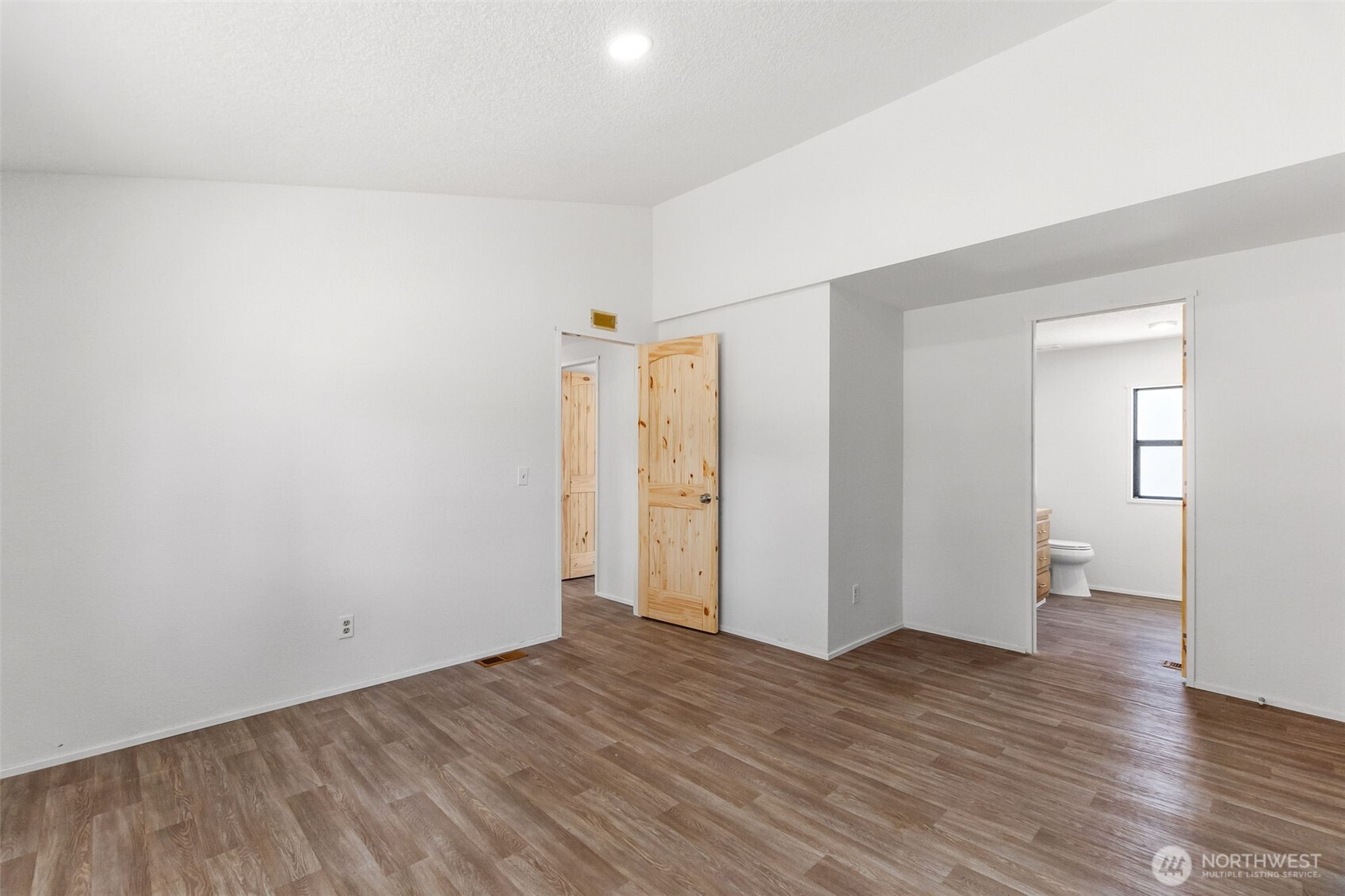 7140 191st Avenue Southwest, Unit 26 Rochester, WA 98579 - Photo 15 of 18 a view of an empty room with wooden floor and closet
