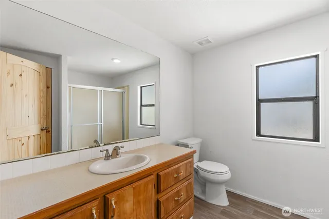 a bathroom with a toilet sink and mirror