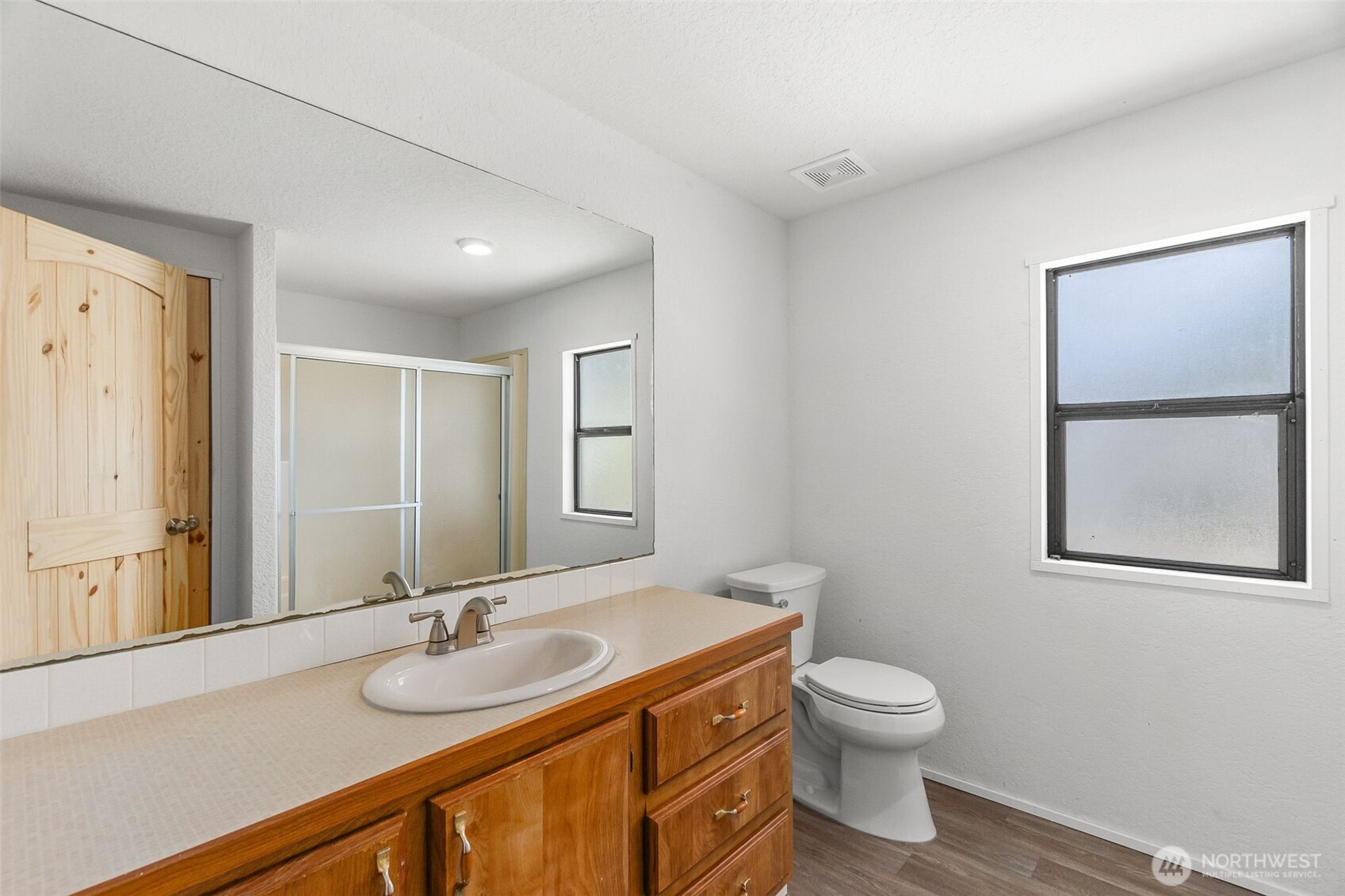 7140 191st Avenue Southwest, Unit 26 Rochester, WA 98579 - Photo 16 of 18 a bathroom with a toilet sink and mirror