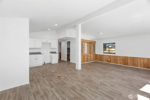 a view of an empty room with a kitchen