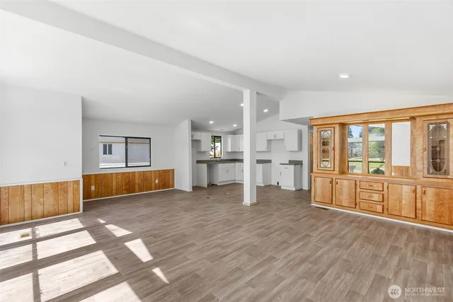 a view of an empty room with a kitchen