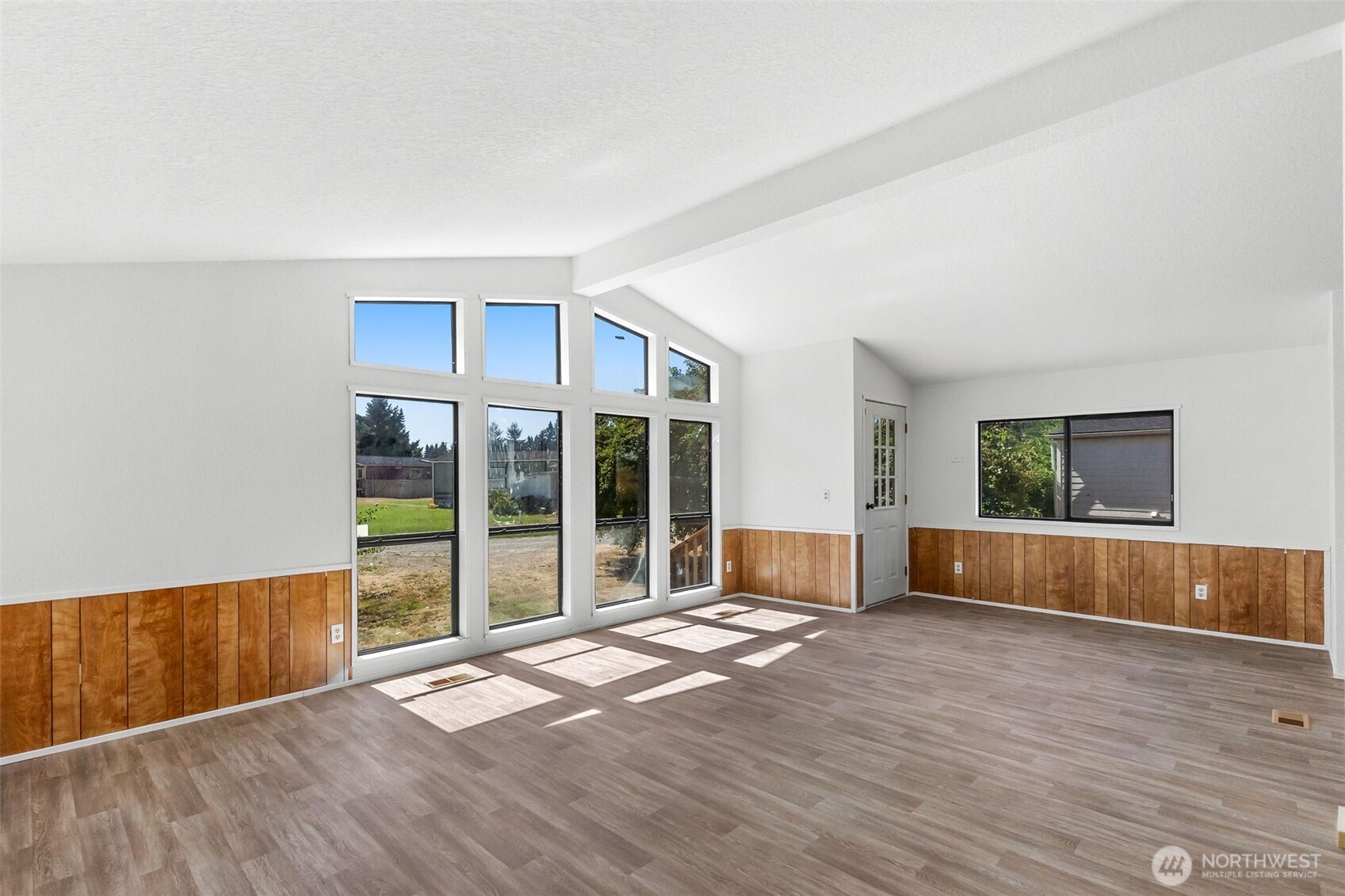 7140 191st Avenue Southwest, Unit 26 Rochester, WA 98579 - Photo 6 of 18 a view of livingroom with furniture and floor to ceiling window
