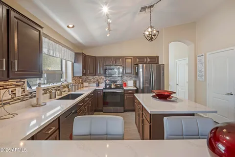 a kitchen with a sink cabinets and window