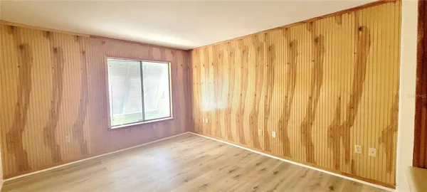 a view of a porch with a door and wooden floor