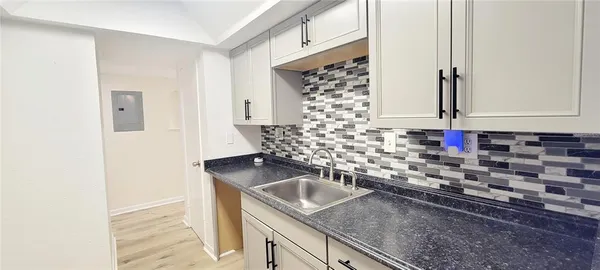 a kitchen with a sink stove and refrigerator