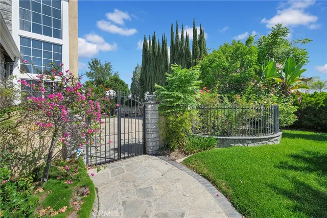 a view of a house with a yard and garden