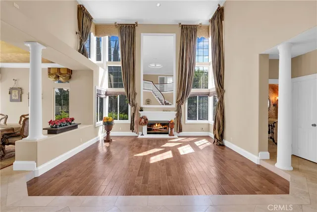 a living room with furniture a fireplace and a floor to ceiling window