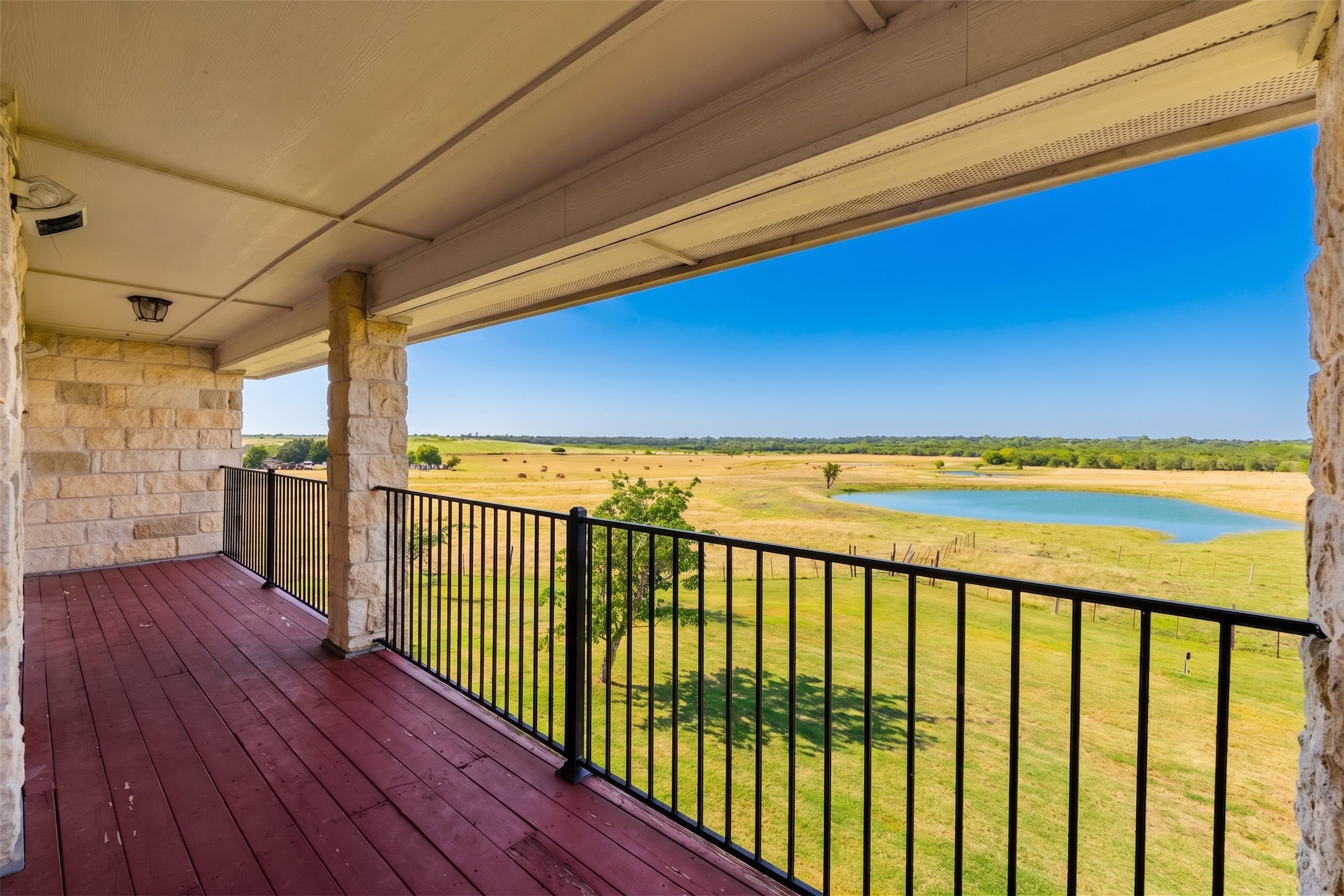 20145 Janak Road Coupland, TX 78615 - Photo 32 of 40 A spacious covered deck overlooks sweeping pastoral views and a serene pond.