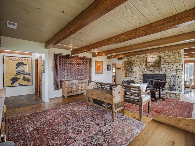a bedroom with a bed table and window