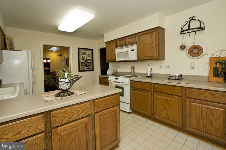 11245 Handlebar Road Reston, VA 20191 - Photo 18 of 27 a kitchen with cabinets appliances and a sink