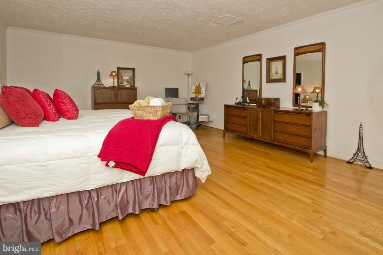 11245 Handlebar Road Reston, VA 20191 - Photo 19 of 27 a living room with a bed couches and a flat tv screen