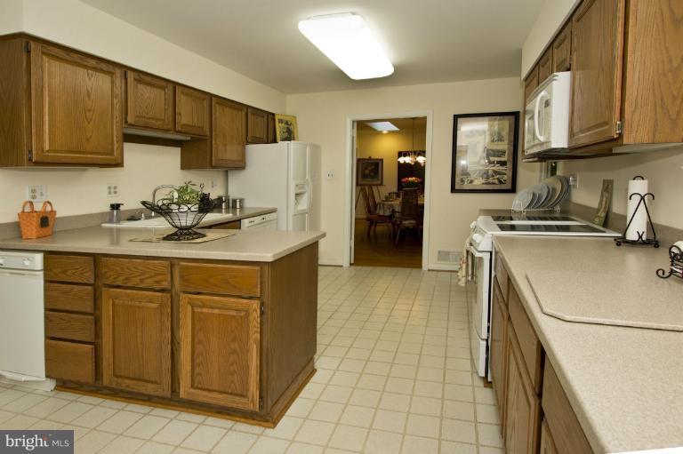 11245 Handlebar Road Reston, VA 20191 - Photo 22 of 27 a kitchen with a sink a stove and refrigerator