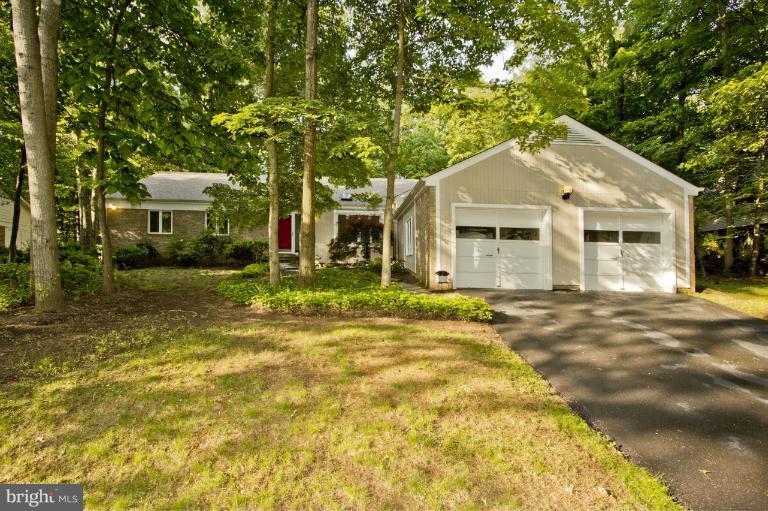 11245 Handlebar Road Reston, VA 20191 - Photo 27 of 27 a view of a white house with a large tree and wooden fence