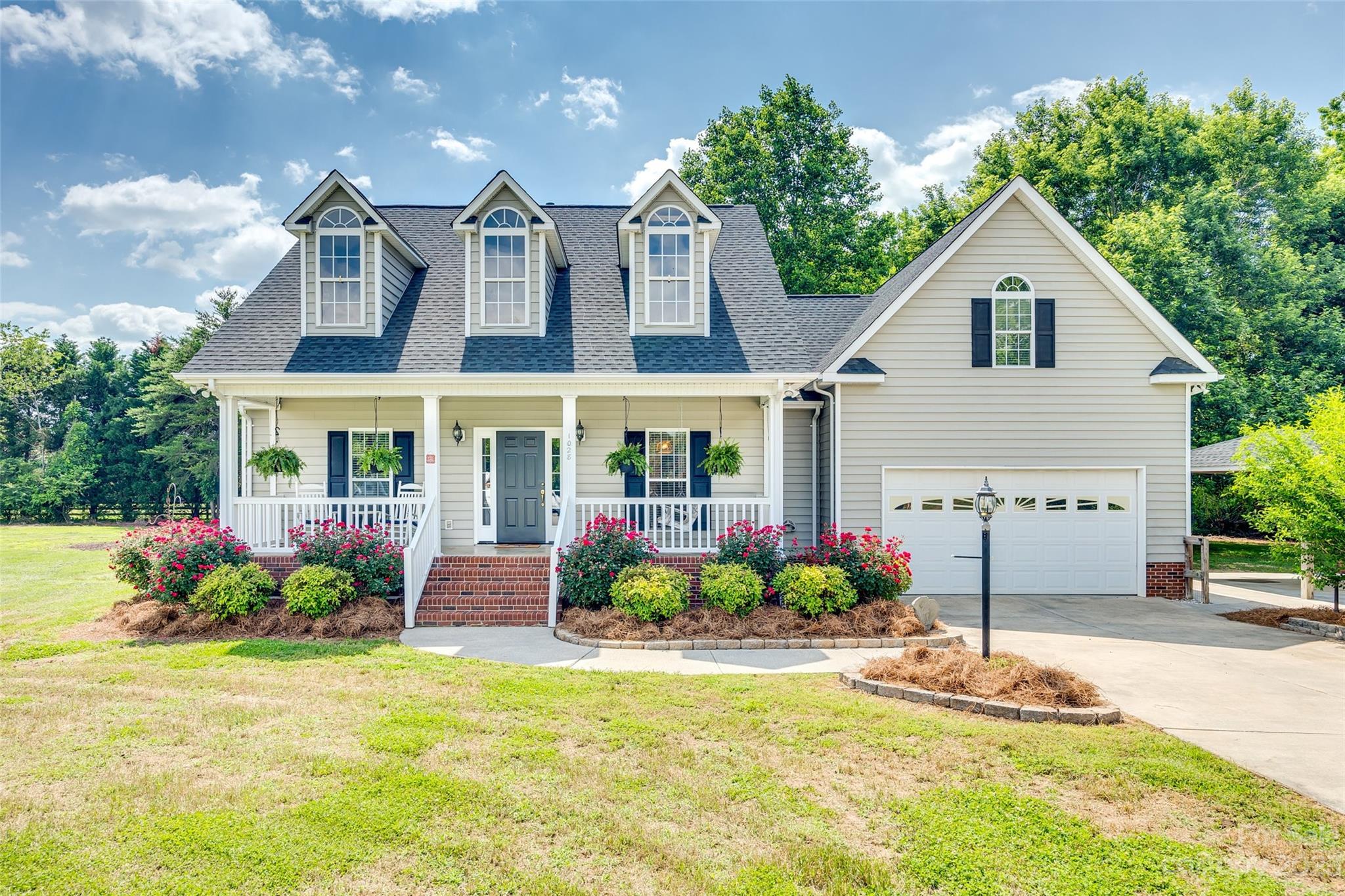 1028 Needles Drive Lancaster, SC 29720 - Photo 1 of 34 a front view of a house with a yard and potted plants