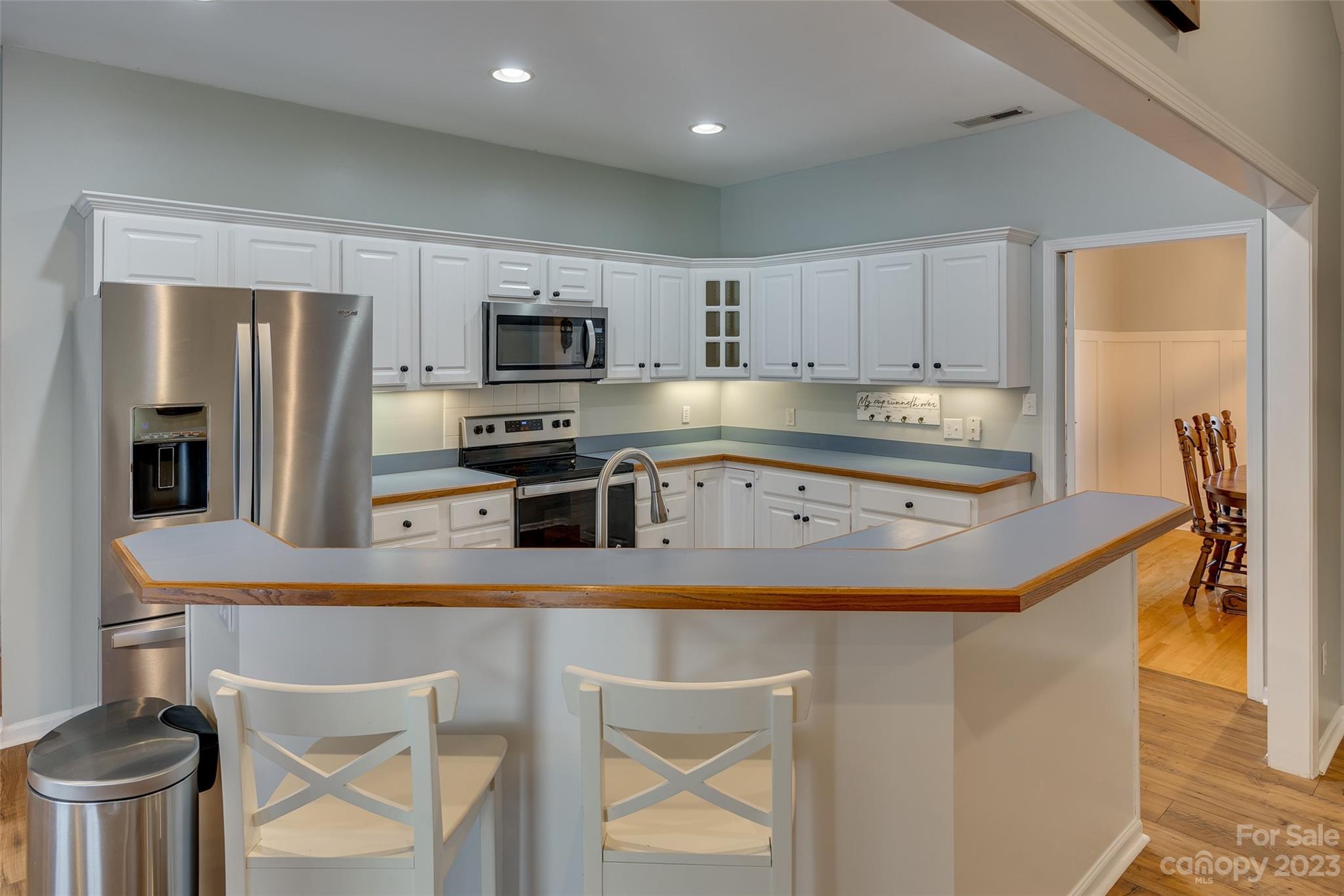 1028 Needles Drive Lancaster, SC 29720 - Photo 12 of 34 a kitchen with kitchen island a stove a sink and a refrigerator