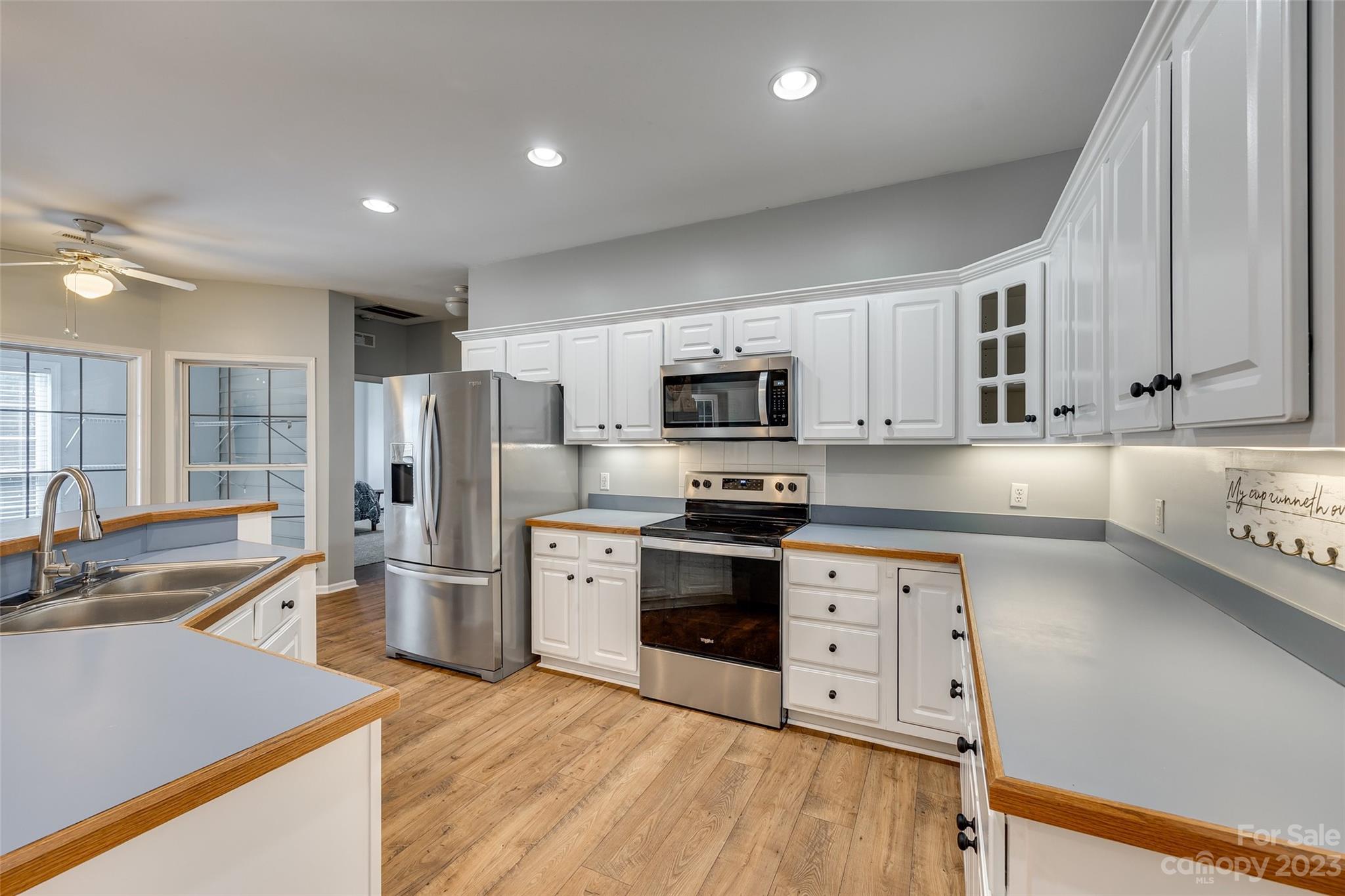 1028 Needles Drive Lancaster, SC 29720 - Photo 13 of 34 a kitchen with stainless steel appliances granite countertop a refrigerator stove microwave and sink