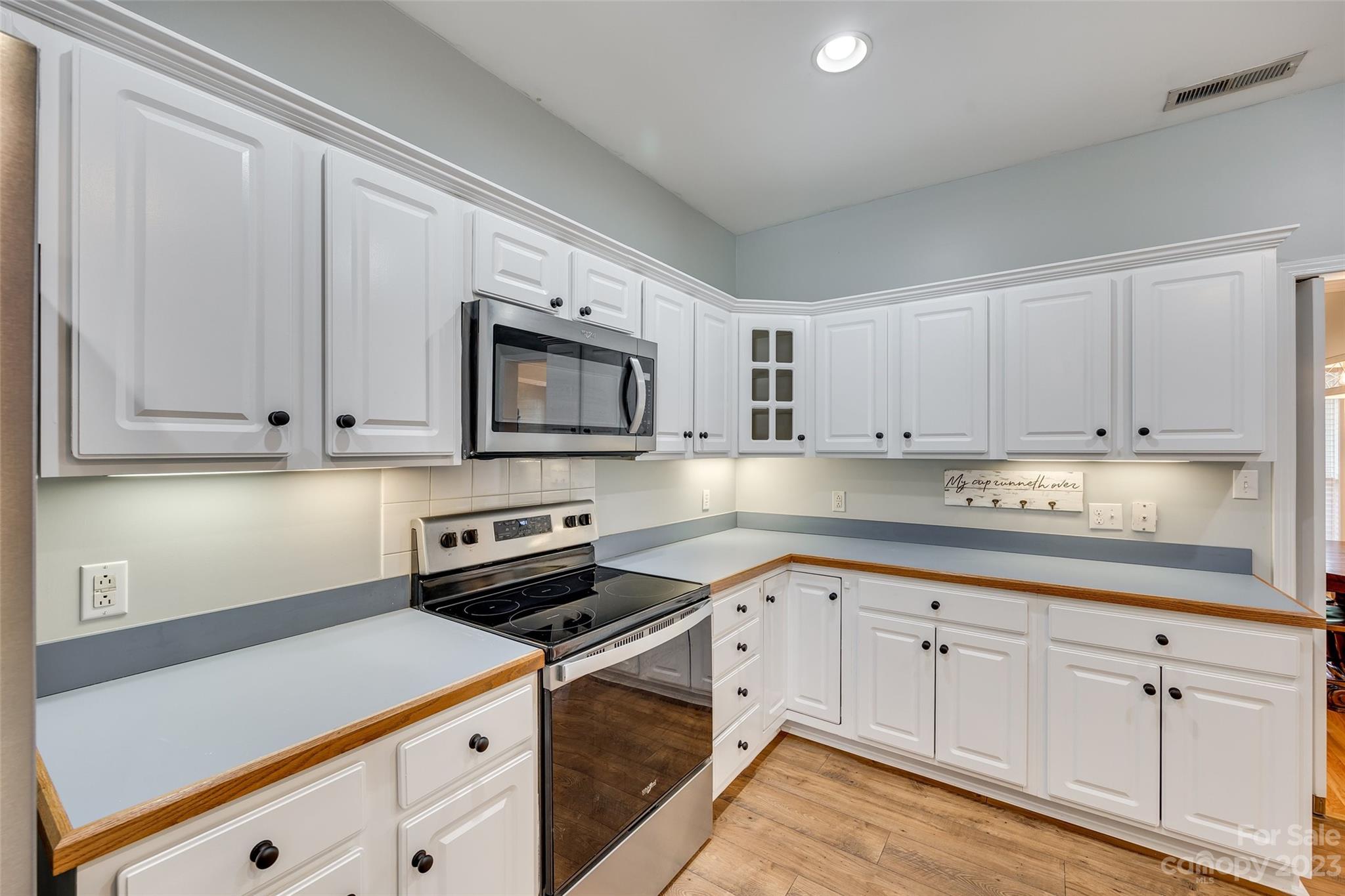 1028 Needles Drive Lancaster, SC 29720 - Photo 14 of 34 a kitchen with granite countertop white cabinets and stainless steel appliances