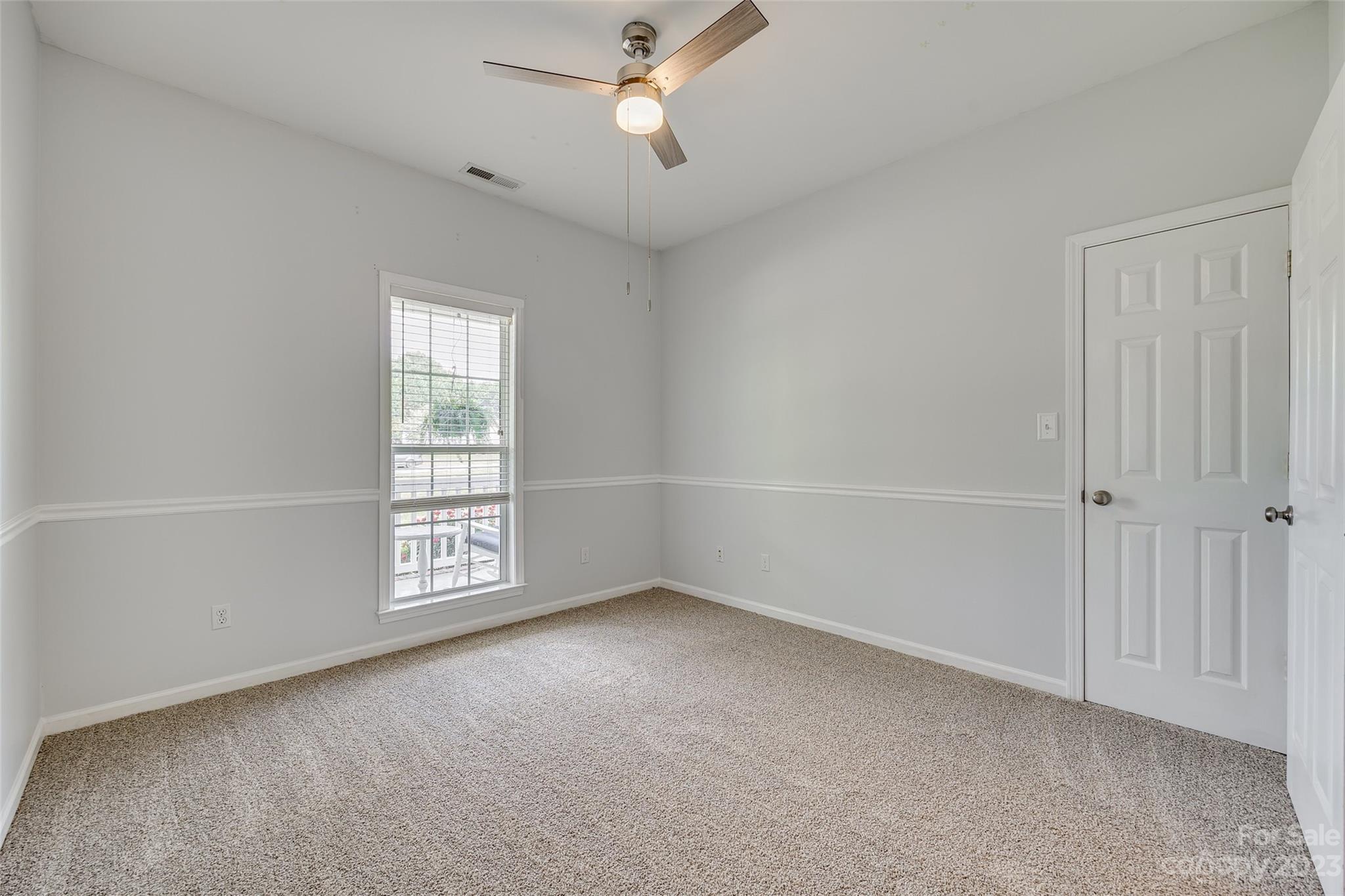 1028 Needles Drive Lancaster, SC 29720 - Photo 19 of 34 an empty room with windows and fan