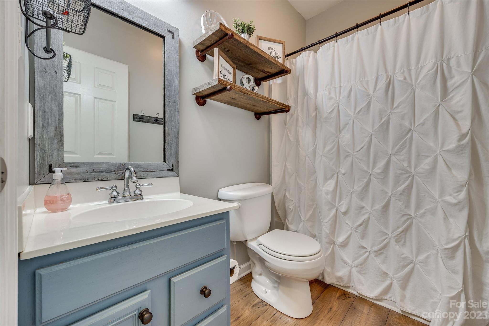 1028 Needles Drive Lancaster, SC 29720 - Photo 21 of 34 a bathroom with a toilet a sink and a mirror